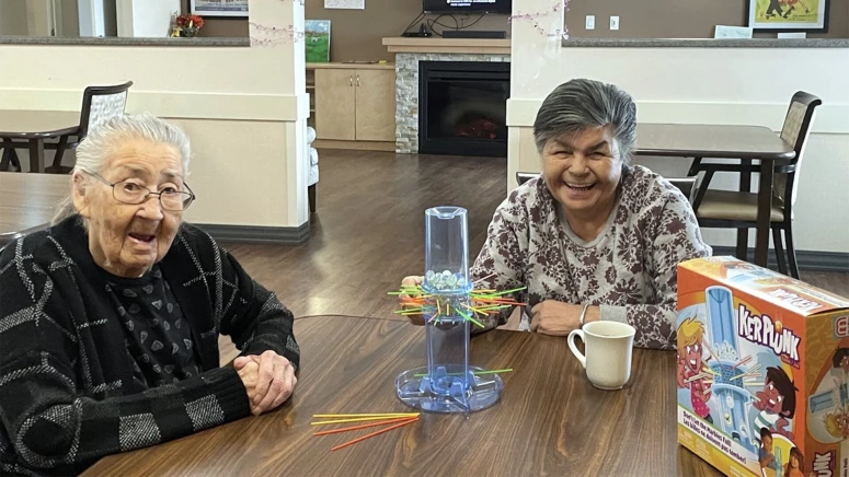Two elderly women playing Kerplunk