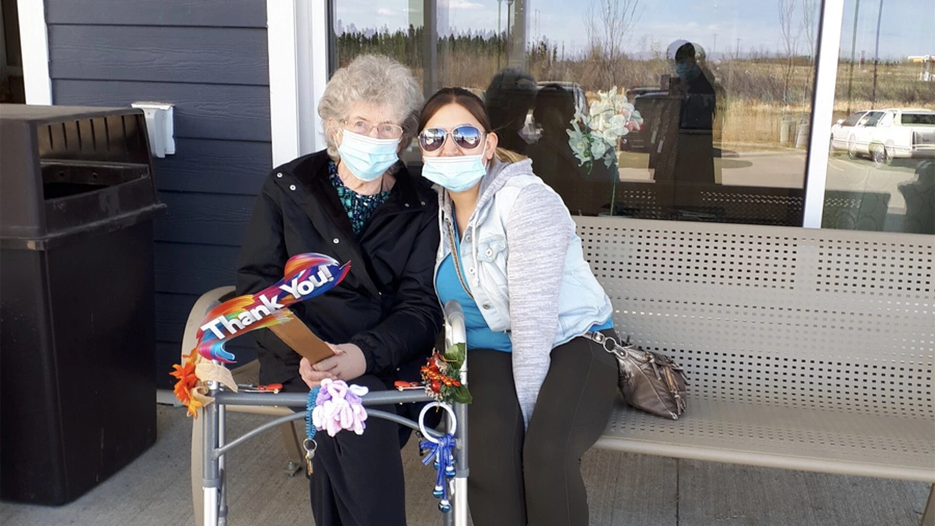 A young woman sitting with elderly lady at Golden sands